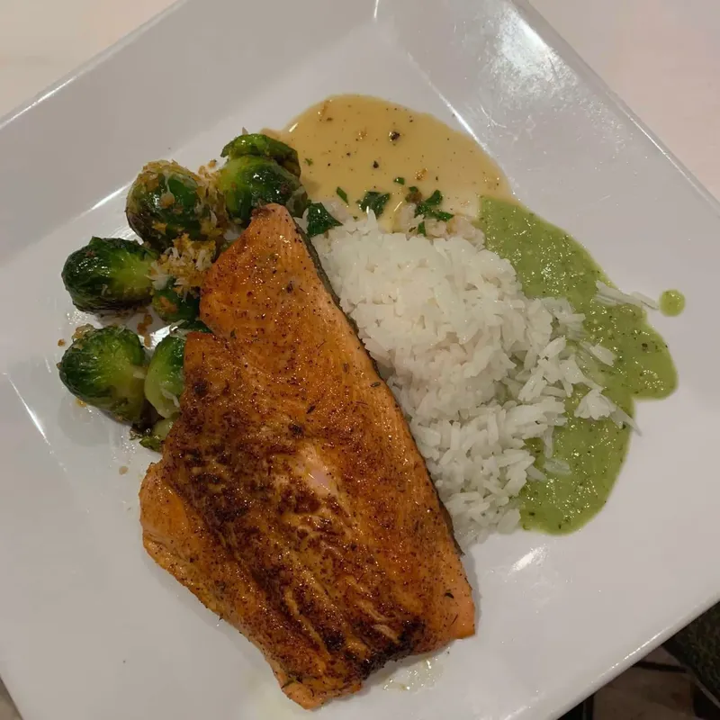 Seared salmon with rice, Brussels sprouts and green sauce