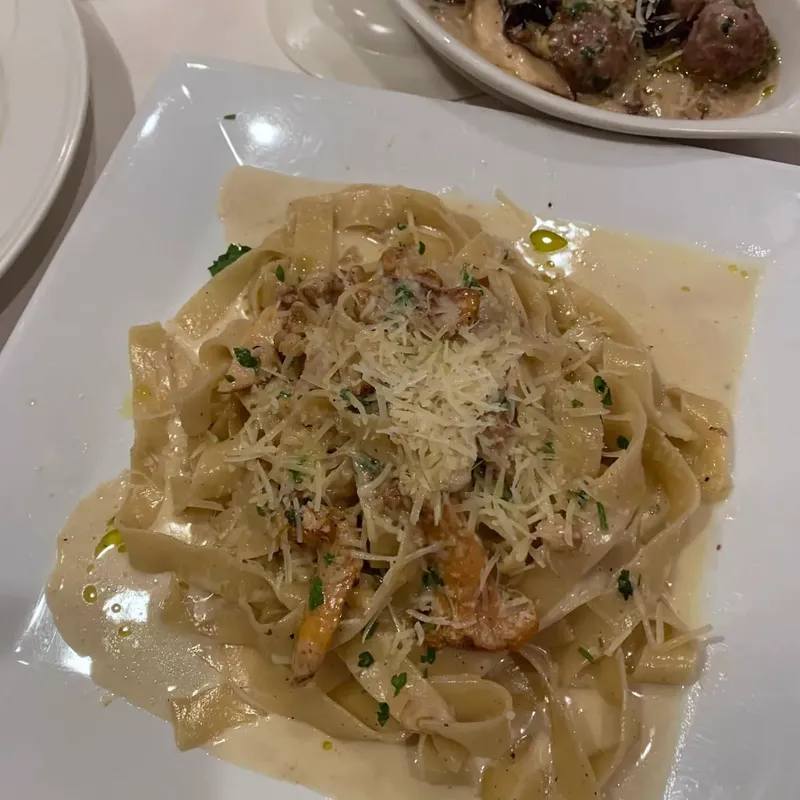 Tagliatelle in a creamy sauce topped with grated cheese